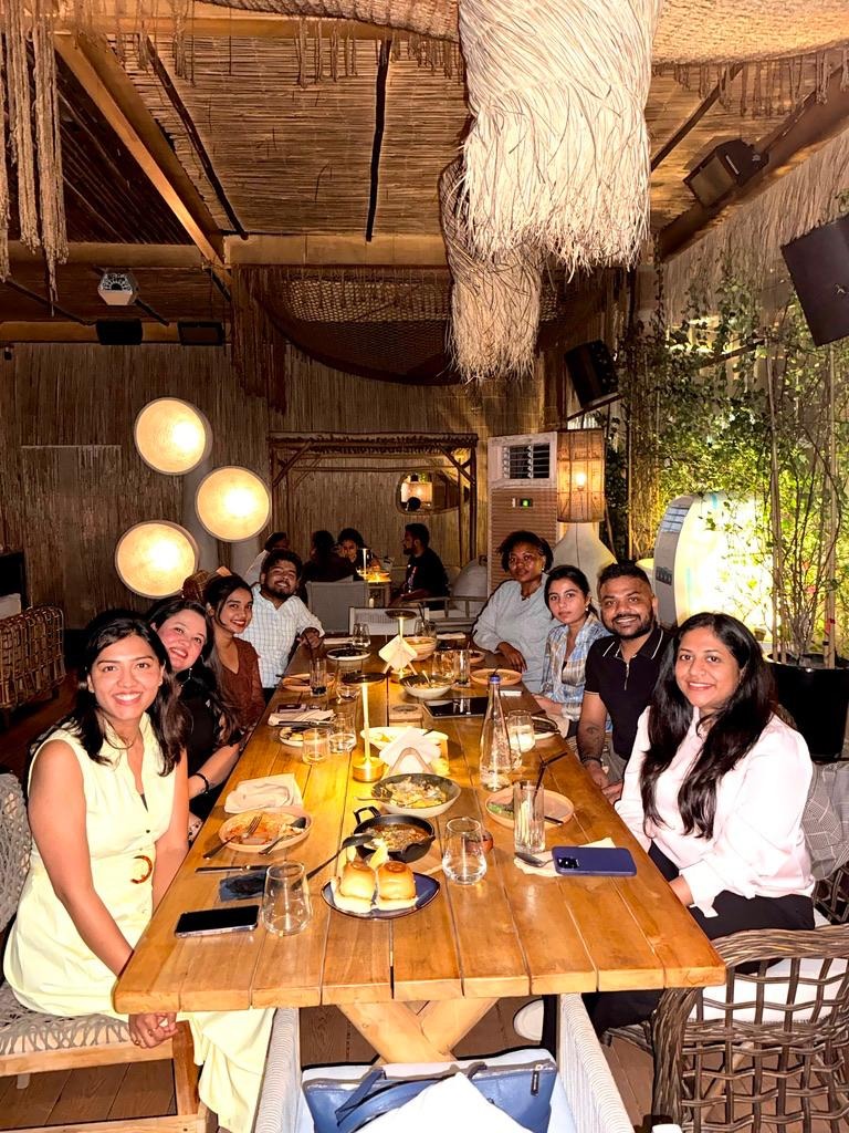 ScaleX Tax team gathered around a long dinner table celebrating together